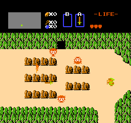 Link stands in the overworld in The Legend of Zelda on NES.