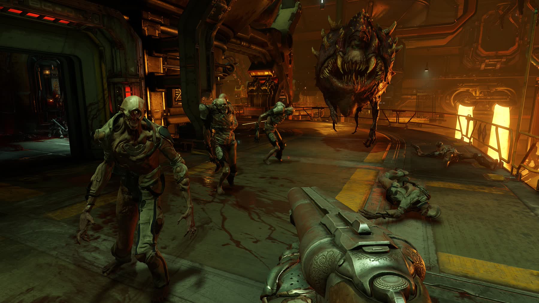 The Doom Slayer fights demons inside a UAC facility in DOOM 2016
