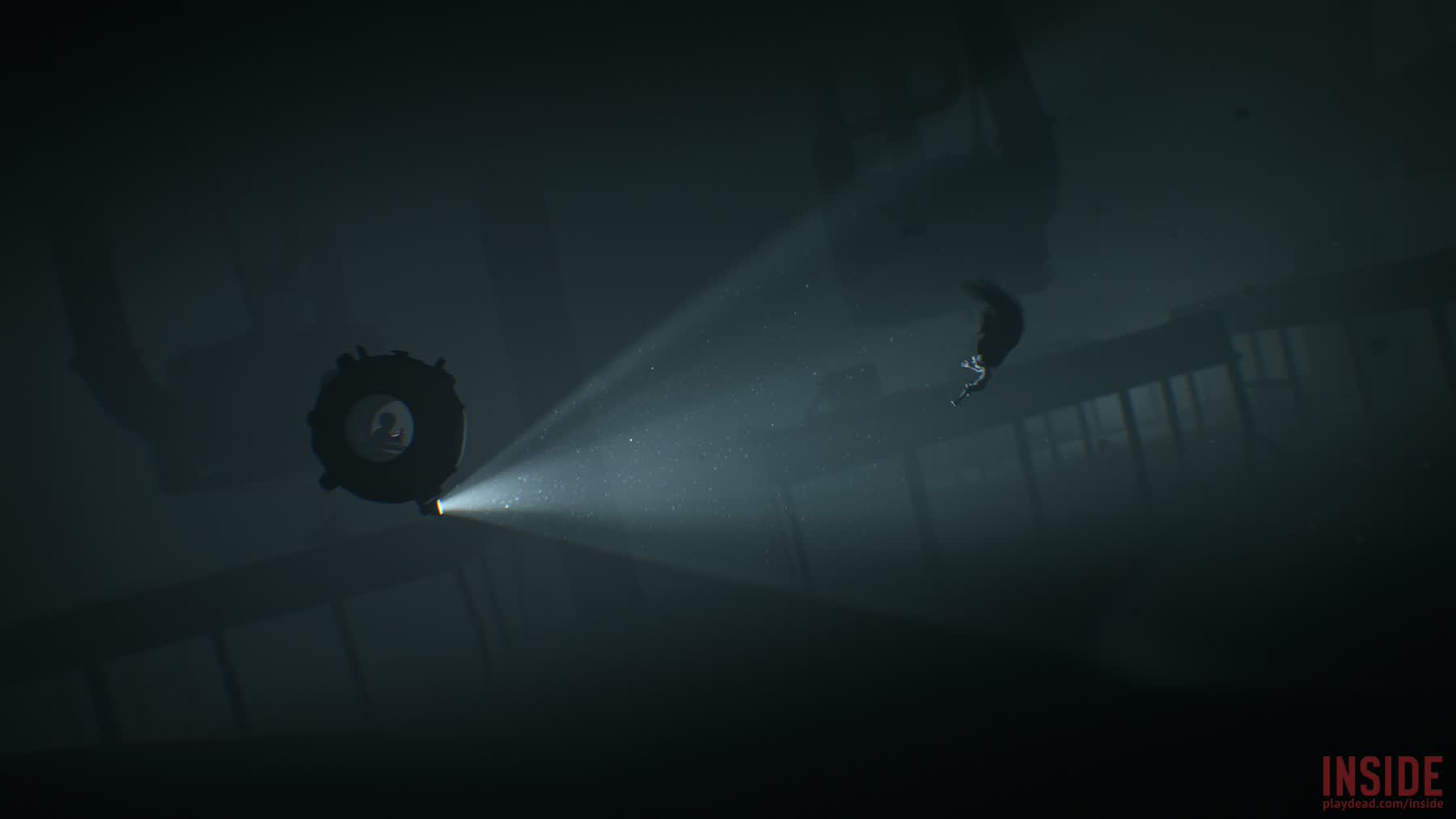 The boy swims through a dark underwater area in Inside